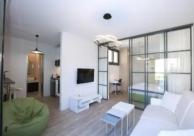 a living room with a white couch and a tv at Emily in Athens - Central chic flat with terrace Syntagma E1 in Athens