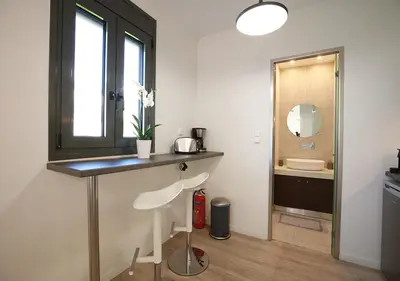 a bathroom with a counter and a sink and a mirror at Emily in Athens - Central chic flat with terrace Syntagma E1 in Athens