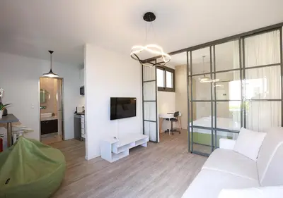 a living room with a white couch and a tv at Emily in Athens - Central chic flat with terrace Syntagma E1 in Athens