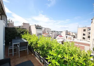 a balcony with a desk and plants on a building at Emily in Athens - Central chic flat with terrace Syntagma E1 in Athens