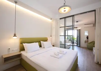 a bedroom with a large bed with two towels on it at Emily in Athens - Central chic flat with terrace Syntagma E1 in Athens
