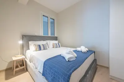 a bedroom with a large bed with towels on it at Stylish 2BDR Apt by the Acropolis in Athens