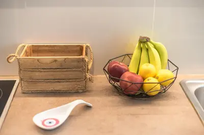 a bowl of fruit on a counter next to a sink at Stylish 2BDR Apt by the Acropolis in Athens