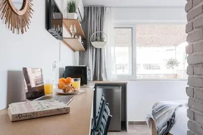 a kitchen with a counter with a table with fruit on it at Wake up with Acropolis view! in Athens