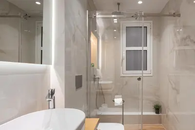 a bathroom with a shower and a toilet and a sink at Acropolis Holmes Residence in Athens