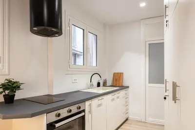 a white kitchen with a sink and a stove at Acropolis Holmes Residence in Athens