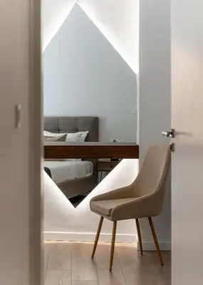 a bedroom with a desk and a chair in front of a mirror at Acropolis Holmes Residence in Athens