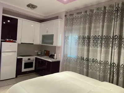 a small kitchen with a bed in a room at Piraeus Cozy Stylish, Fully Reno Apt, near metro in Piraeus
