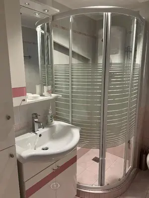 a bathroom with a sink and a shower at Piraeus Cozy Stylish, Fully Reno Apt, near metro in Piraeus