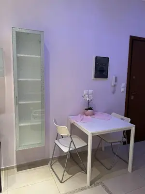 a white table and chairs in a room with a purple wall at Piraeus Cozy Stylish, Fully Reno Apt, near metro in Piraeus