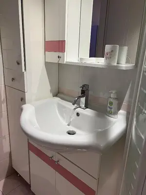 a bathroom with a white sink and a mirror at Piraeus Cozy Stylish, Fully Reno Apt, near metro in Piraeus