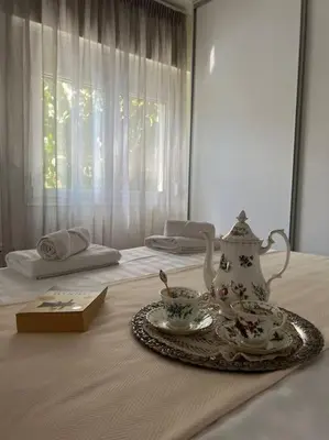 a bed with a tray with a tea set on it at Luxury Studio “Atene” in Athens