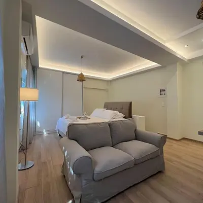a living room with a couch and a bed at Luxury Studio “Atene” in Athens
