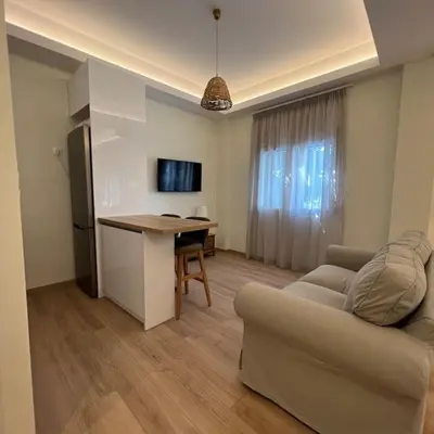 a living room with a couch and a table and a desk at Luxury Studio “Atene” in Athens