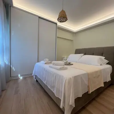 a bedroom with a large bed with white sheets at Luxury Studio “Atene” in Athens