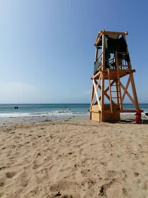 a lifeguard tower on a sandy beach near the ocean at Cosy and Relax Studio by the sea, with garden in Saronida