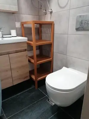 a bathroom with a white toilet and a sink at Cosy and Relax Studio by the sea, with garden in Saronida