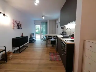 a kitchen with a sink and a stove top oven at Cosy and Relax Studio by the sea, with garden in Saronida