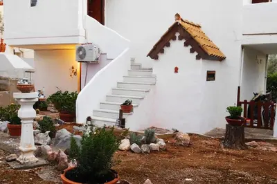 a small house with a staircase in a yard at Marco Polo's Mooring Cozy Navy House in Anavissos