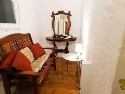 a room with a bench and a table with a mirror at Marco Polo's Mooring Cozy Navy House in Anavissos