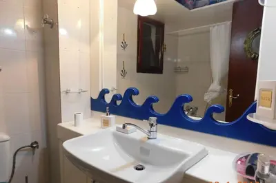 a bathroom with a white sink and a mirror at Marco Polo's Mooring Cozy Navy House in Anavissos