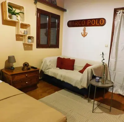 a living room with a couch and a table at Marco Polo's Mooring Cozy Navy House in Anavissos