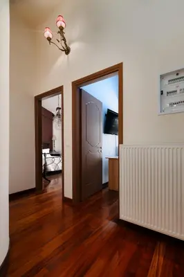 an empty room with two doors and a hard wood floor at Spacious Villa with pool 500m from the beach in Vari