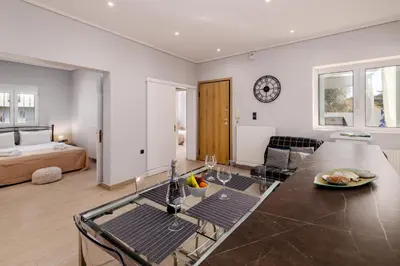 a living room with a glass table and a couch at Spacious Villa with pool 500m from the beach in Vari
