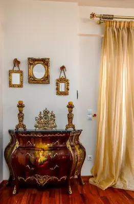 a dresser in a room with a curtain and a mirror at Spacious Villa with pool 500m from the beach in Vari