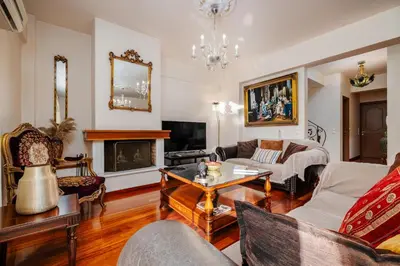 a living room filled with furniture and a fireplace at Spacious Villa with pool 500m from the beach in Vari