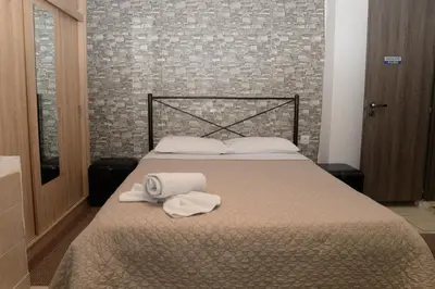 a bedroom with a bed with towels on it at Boutique Kalithea in Athens