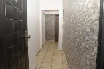 a hallway with a brick wall and a door at Boutique Kalithea in Athens
