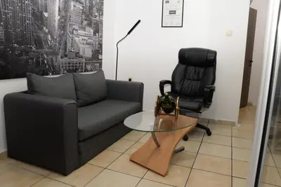 a living room with a couch and a chair at Boutique Kalithea in Athens