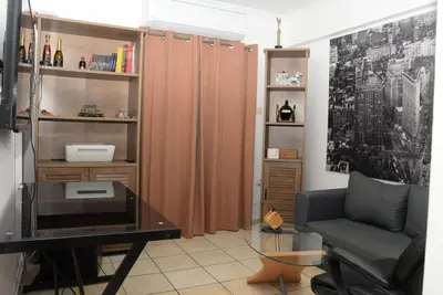 a living room with a couch and a glass table at Boutique Kalithea in Athens
