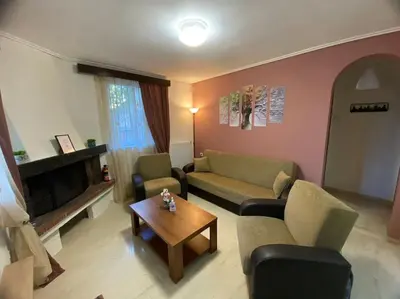 a living room with two couches and a coffee table at Near sea / Airport, Queen size bed, Fireplace in Artemida