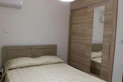 a bedroom with a bed and a large mirror at Near sea / Airport, Queen size bed, Fireplace in Artemida