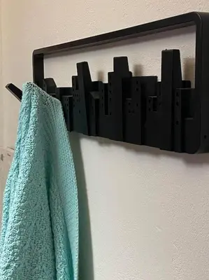 a towel hanging on a wall with a picture of a city at Near sea / Airport, Queen size bed, Fireplace in Artemida