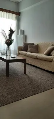 a living room with a couch and a coffee table at Koukaki View in Athens