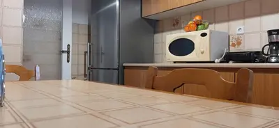 a kitchen with a table and a microwave at Koukaki View in Athens