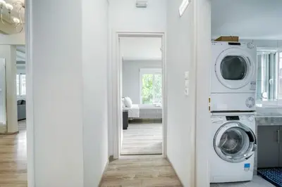 a white laundry room with a washer and dryer at Charming Contemporary 2 bedroom apartment in Athens
