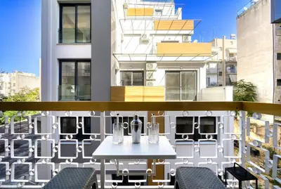 a balcony with a table and chairs on a building at Blue Horizon - City Center Close to Metro in Athens