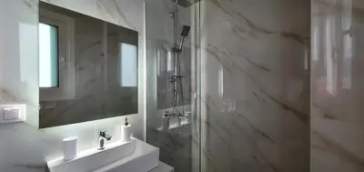 a bathroom with a sink and a shower and a mirror at Blue Horizon - City Center Close to Metro in Athens