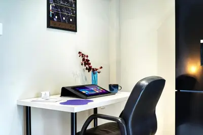 a desk with a laptop and a chair on it at Blue Horizon - City Center Close to Metro in Athens