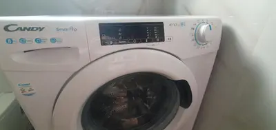 a white washing machine sitting next to a wall at Blue Horizon - City Center Close to Metro in Athens