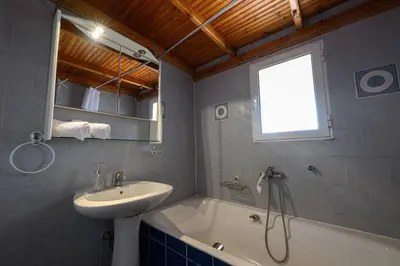 a bathroom with a sink and a bath tub and a sink at FarmBill in Markopoulo