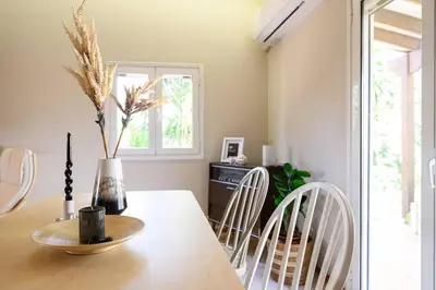 a dining room with a table with white chairs at FarmBill in Markopoulo