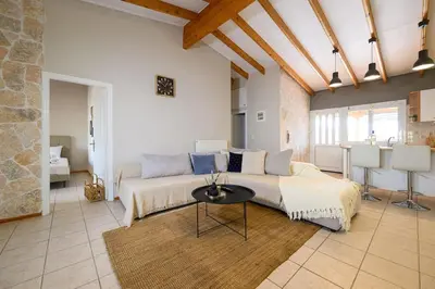 a large bedroom with a large bed and a table at FarmBill in Markopoulo