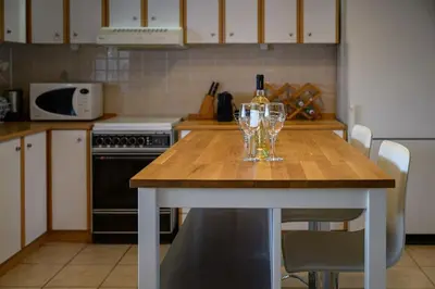 a kitchen with a table with two wine glasses on it at FarmBill in Markopoulo
