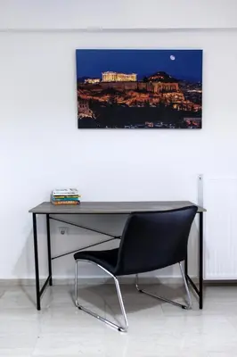 a black desk with a black chair in a room at Meandros apartment city center in Athens