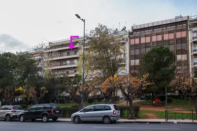 a group of cars parked in front of a building at Meandros apartment city center in Athens